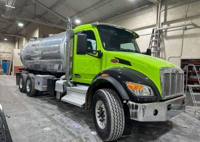 A custom paint job for a Peterbuilt semi truck. Duotone with a bright lime green body and black fender accents