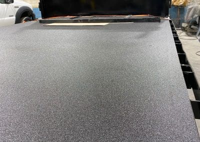 A custom flatbed work truck sprayed with a high quality protective bedliner coating by Vortex Sprayliners