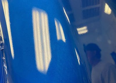 Closeup detail photo of a high gloss blue paint on a semi truck