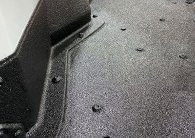 Closeup photo of the floor of a service van sprayed with high quality bedliner material by Vortex Sprayliners to protect the floor from damage.