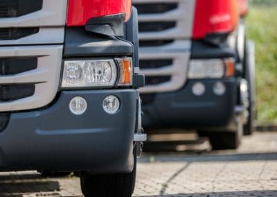 Red Fleet semi trucks, detail photo of the headlights